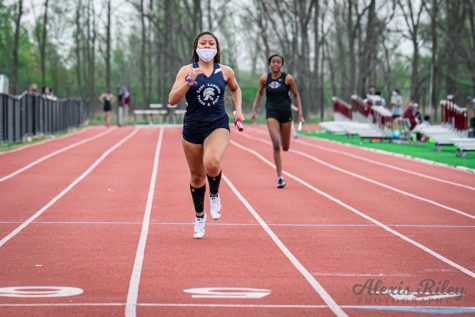 Jaida Thomas finishes the relay race at Okemos High School. Photo courtesy of Jaida Thomas