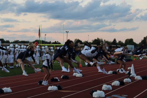 The East Lansing varsity cheer on Sept. 24 at an away game in DeWitt, cheer will accompany the football team as well as engage with the visiting student section.