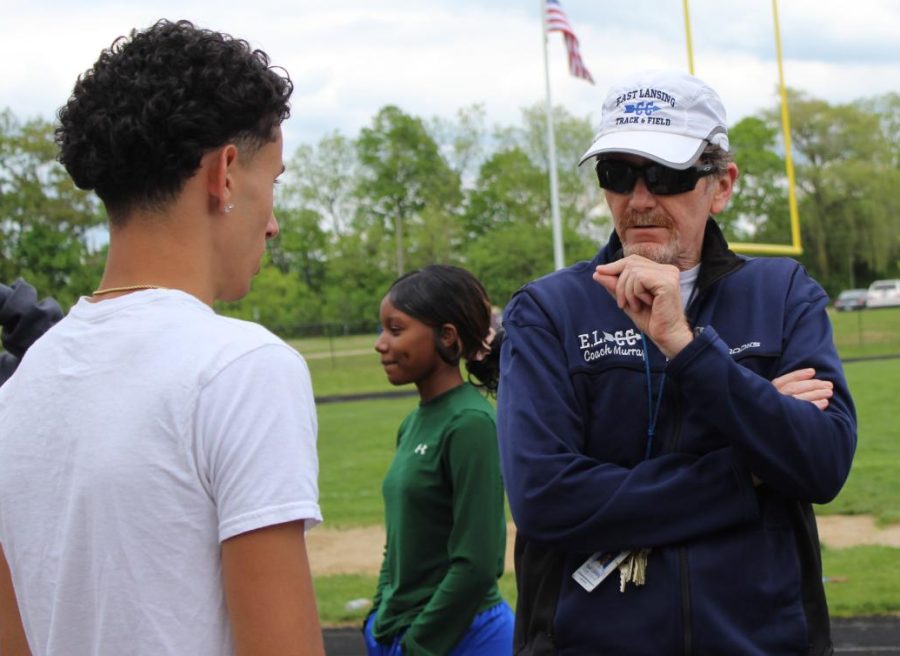 Advising an athlete on his form, English teacher and coach Patrick Murray leads track practice on May 23. "I tell my athletes, success... is not the outcome, its the process," Murray said.