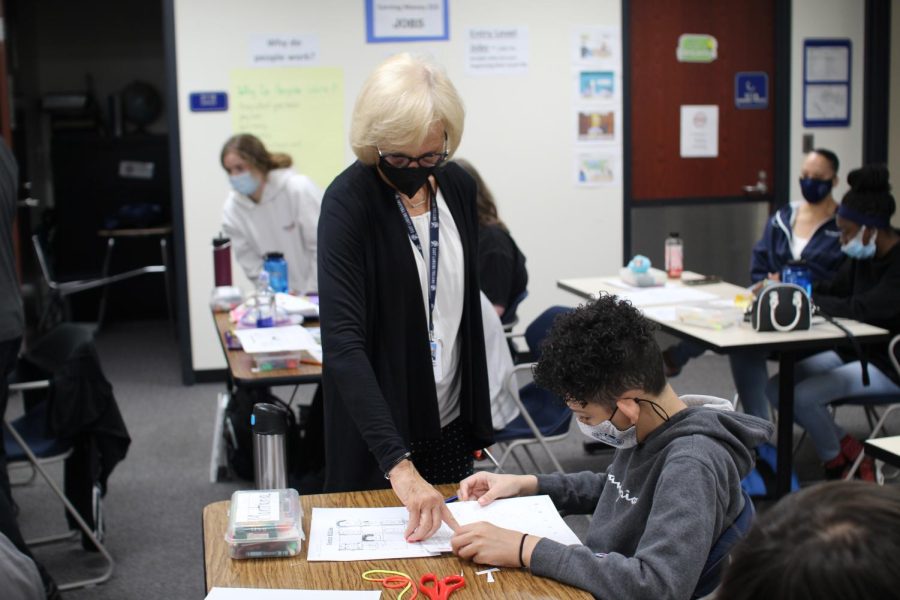 Barb McCaffrey helps Montana Washington (10) in her special-needs classroom.  McCaffrey often works with students between four to six years, from when they walk into her room to when they walk across the graduation stage.