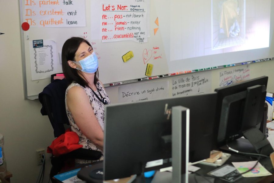 Laughing with her class on May 19, French teacher Marcy Sheldon shows a movie to her combined AP French and Careers in French class. As the department chair of World Languages, Sheldon has overseen major changes to how language is taught.