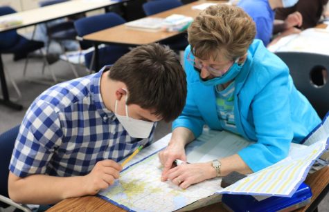 Helping Joseph DeRogatis-Frilingos (11), paraprofessional Amy Celentino advises on a geography activity. Celentino has worked in the district for 24 years, and has seen many students come and go through the special education program.
