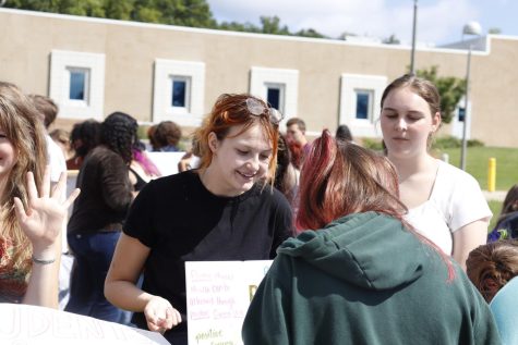Advertising her new club: Be a Positive Somebody, Sydney Isham (12) speaks to Kate McAndrews (12) at club rush on Sept. 13.