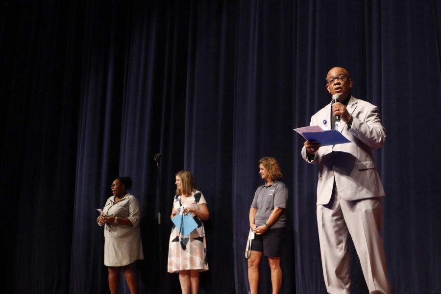 Principal Mr. Mayfield, assistant principals Ms. Schwarzbek and Ms. Davis, and athletic director Ms. Norris stand on stage at freshman orientation.