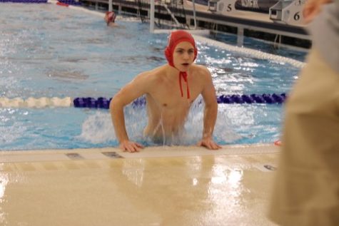 Jonah Robertson (9) getting out of the pool at the regional water polo competition on Jan. 13. 