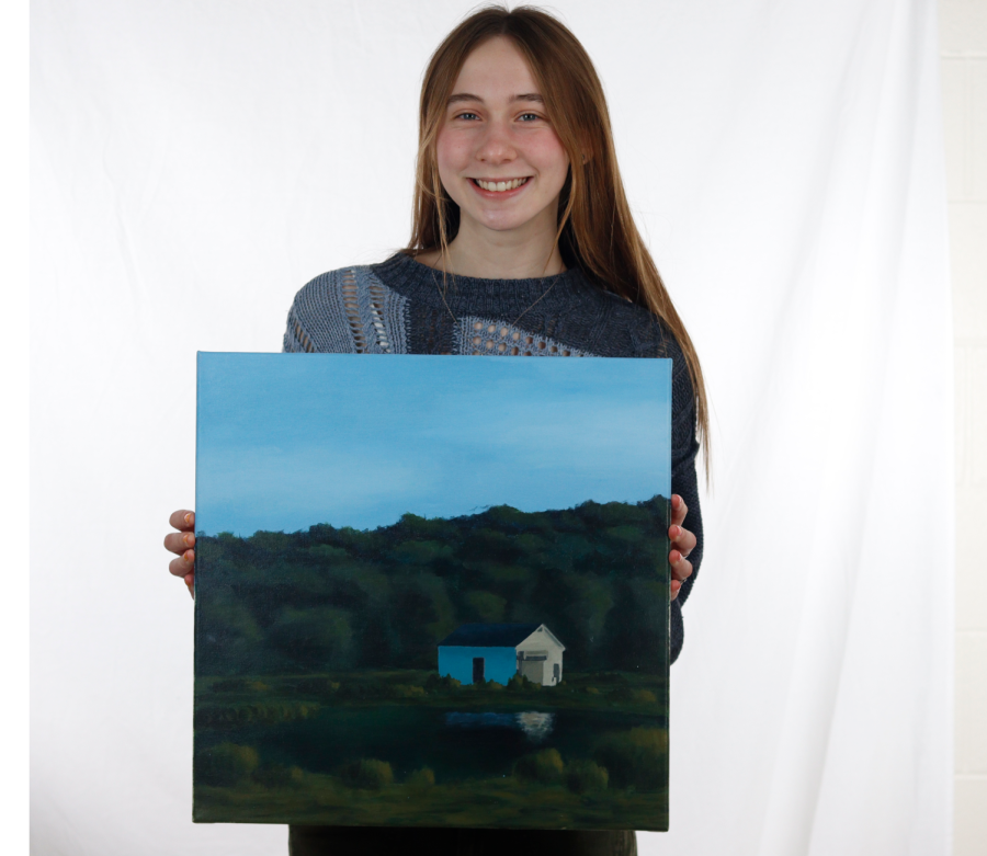 Smiling, Gwen Petrie (12) holds her painting, Chautauqua that she entered into the competition.