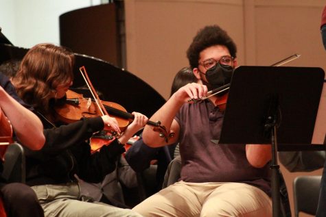 Meera Schenker (12) and Joshua Johnson (12) playing during class on April 18, the day before the senior solos concert. Photo by Joelle King