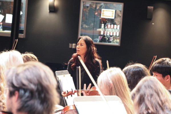 Soon Hee Newbold working with orchestra class during rehearsals.  