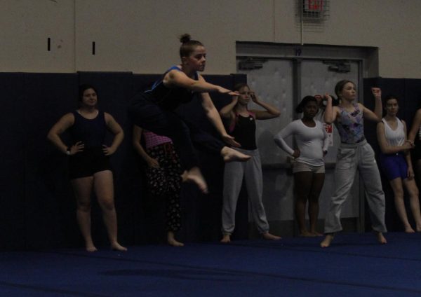 Sarah Bollman (12) performs a jump during practice