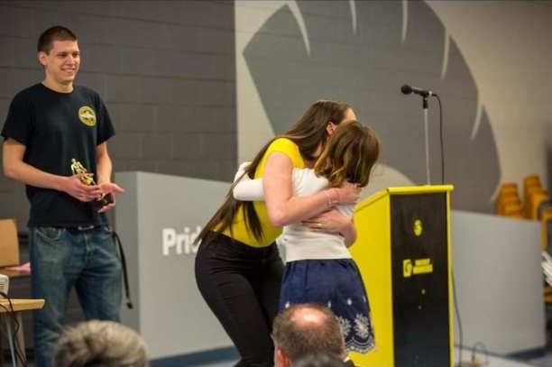 While at a swim banquet, a 9 year old Belle Potter (10) embraces her coach before receiving an award. Potter was a member of the Waverly Piranhas Swim Club from 2016 to 2022. (Courtesy Photo)
