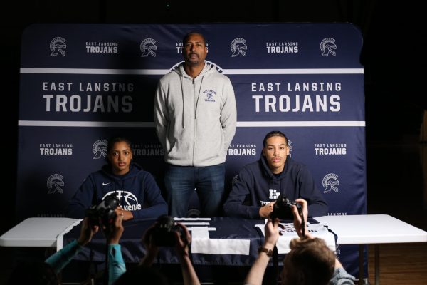Cameron Hutson (11), Sydney Hutson (9), and their father, former MSU basketball player Andre Hutson pose on March 12. 