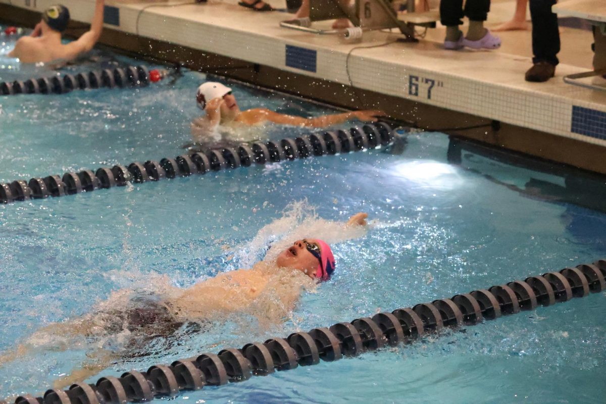 Jackson+Gast+%2810%29+raced+to+complete+his+100+meter+backstroke+at+the+boys+swim+and+dive+Capital+Area+Athletic+Conference+meet+on+Feb.+23.