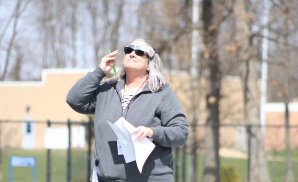Earth and space science teacher, Geralynn Jackson instructs her class outside during the solar eclipse on April 8.