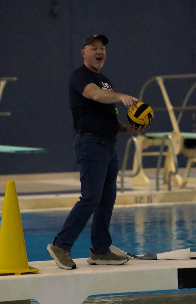 Head girls water polo coach, Brian Fickies adjusts a drill during practice on April 4.