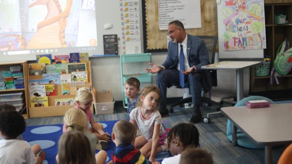 Cardona sits with Mrs. Fortner's Kindergarten class, introducing himself.