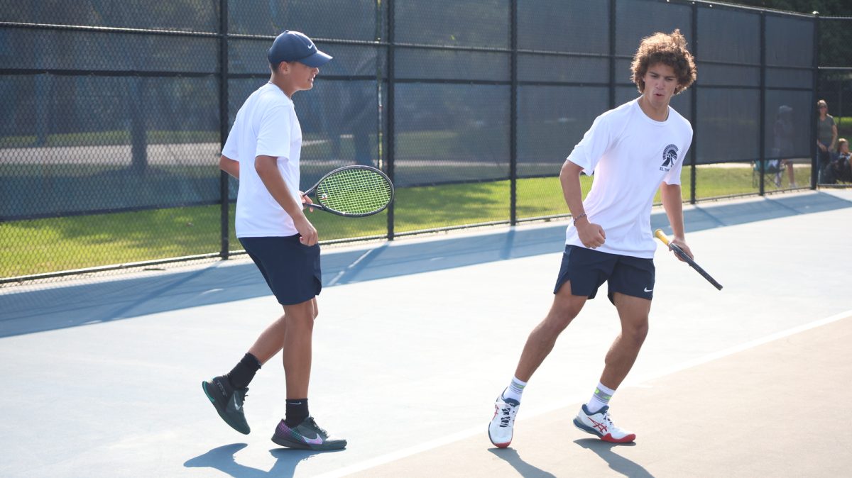 Gerrit Garcia (12) plays with his doubles partner Henry Mahler (12) against
Okemos on Sep. 11