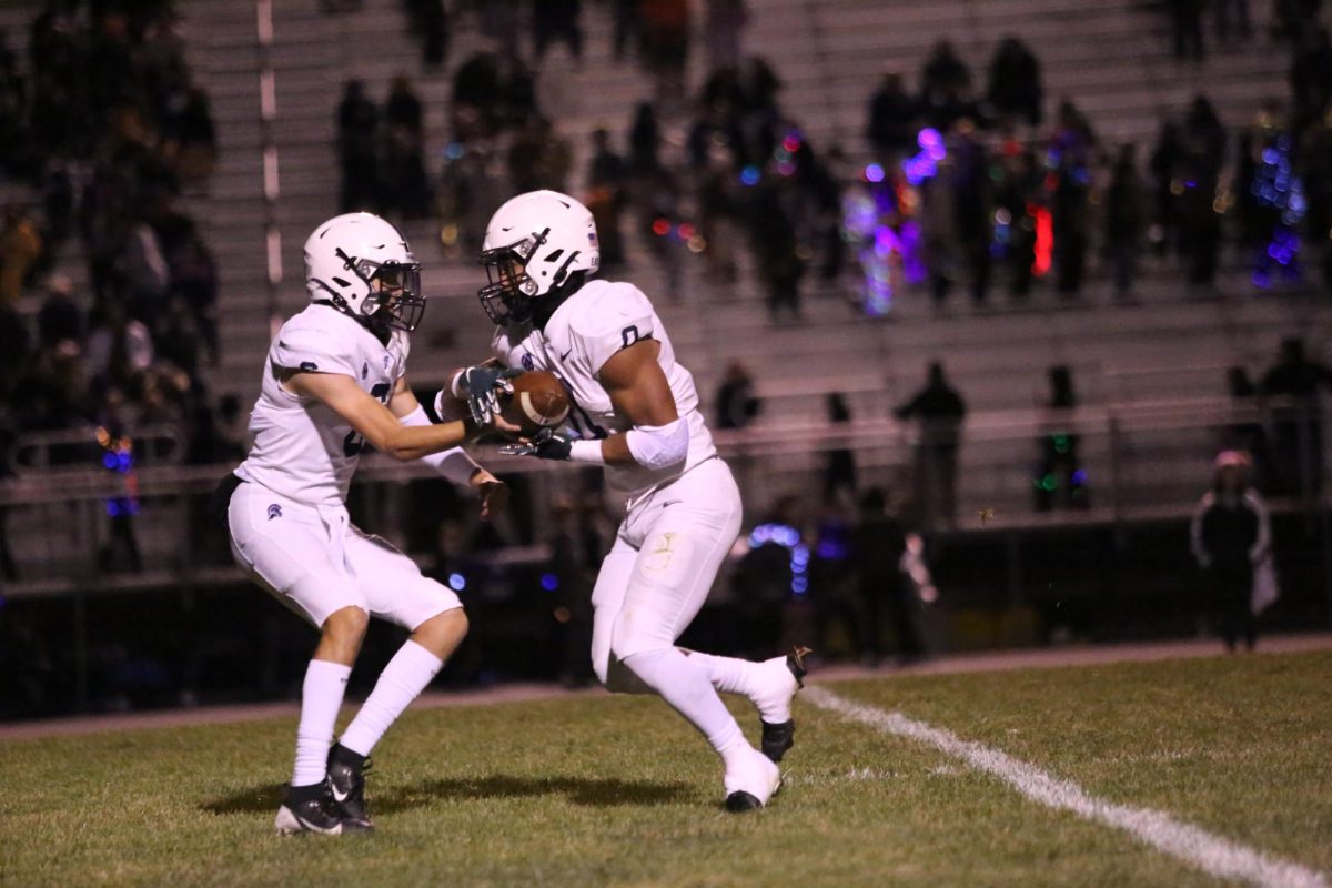 Jace Clarizio (12) takes handoff from quarterback Ben Fletcher (12).  In the game against Holt Clarizio had 3 touchdowns and 141 rushing yards.