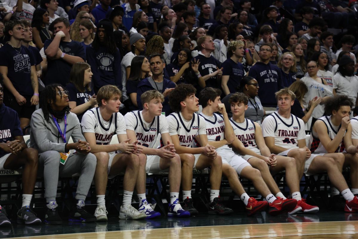 Sitting on the sidelines (pictured left to right) David Foster (12), Henry Peck (11), Isaiah Lott (12), Ben Fletcher (12), Owen Fortman (12), Paul VanDam (11), and Brady Johns (11) watch as their team plays in the MHSAA basketball state finals. 