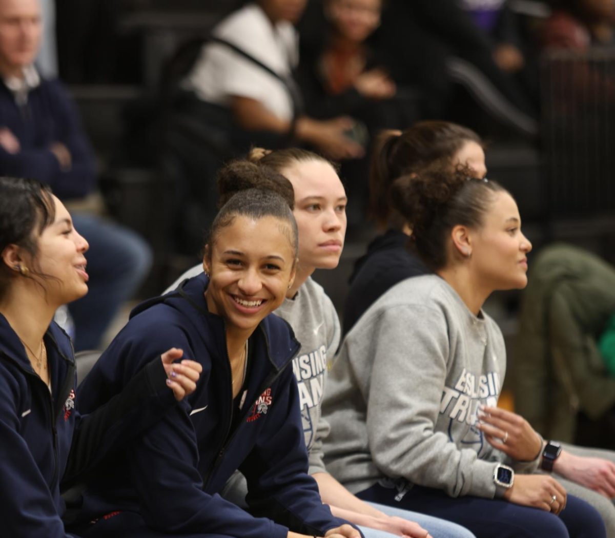 Ariyana James (12) sits on the bench alongside her teammates. After being named to the CAAC Blue All-League team last year, James suffered a stroke during preseason this year, causing her to be out for  season. 