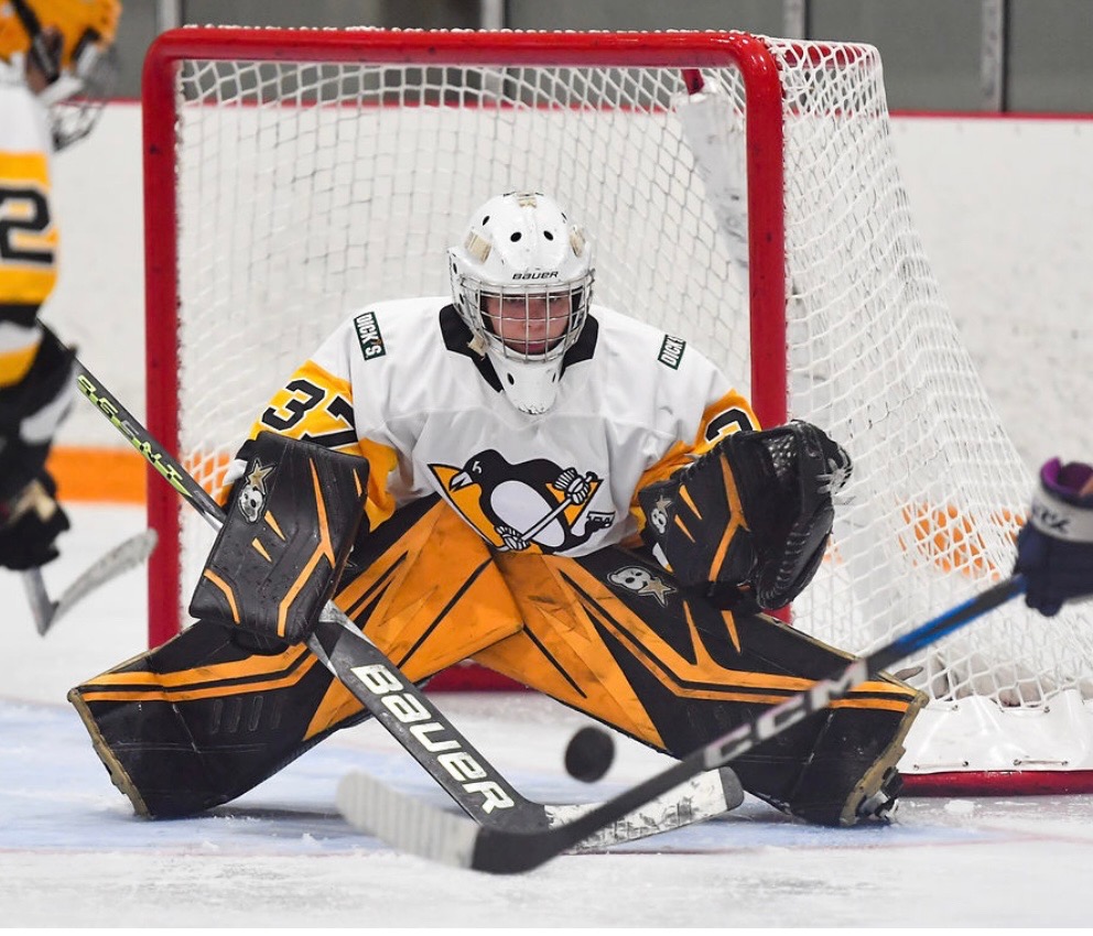 Ainsley Adams (12) blocks a shot during a girls ice hockey game for her new team, the Pittsburgh Penguins. Adams uprooted her life to move to Pittsburgh last August to play for this team. 