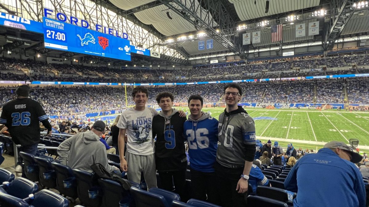 Jonny Kalt (12) stands with his brother Benny Kalt ('22) and cousins at Ford Field before a Lions game. Watching the Lions is a family tradition for the Kalts. Courtesy photo.