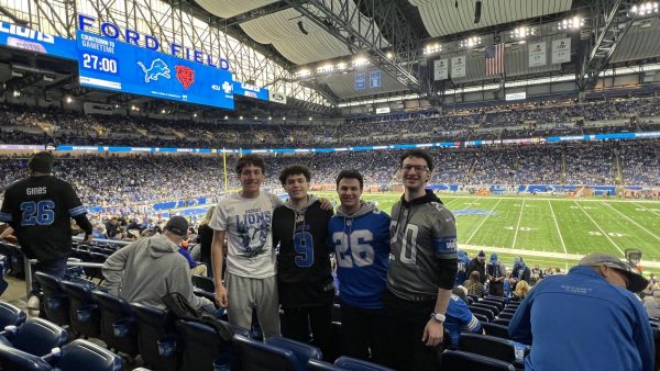 Jonny Kalt (12) stands with his brother Benny Kalt ('22) and cousins at Ford Field before a Lions game. Watching the Lions is a family tradition for the Kalts. Courtesy photo.