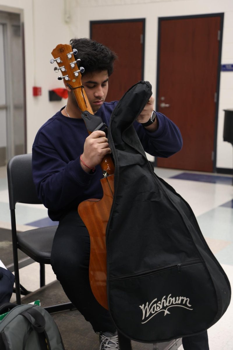 After auditioning on Jan 8, Pranjal Privthi (12) places his guitar back in his case. Privthi sang the folk song “Tomar Ghore Bose" to a group of Student Council members, which they approved for the assembly on Feb 6.