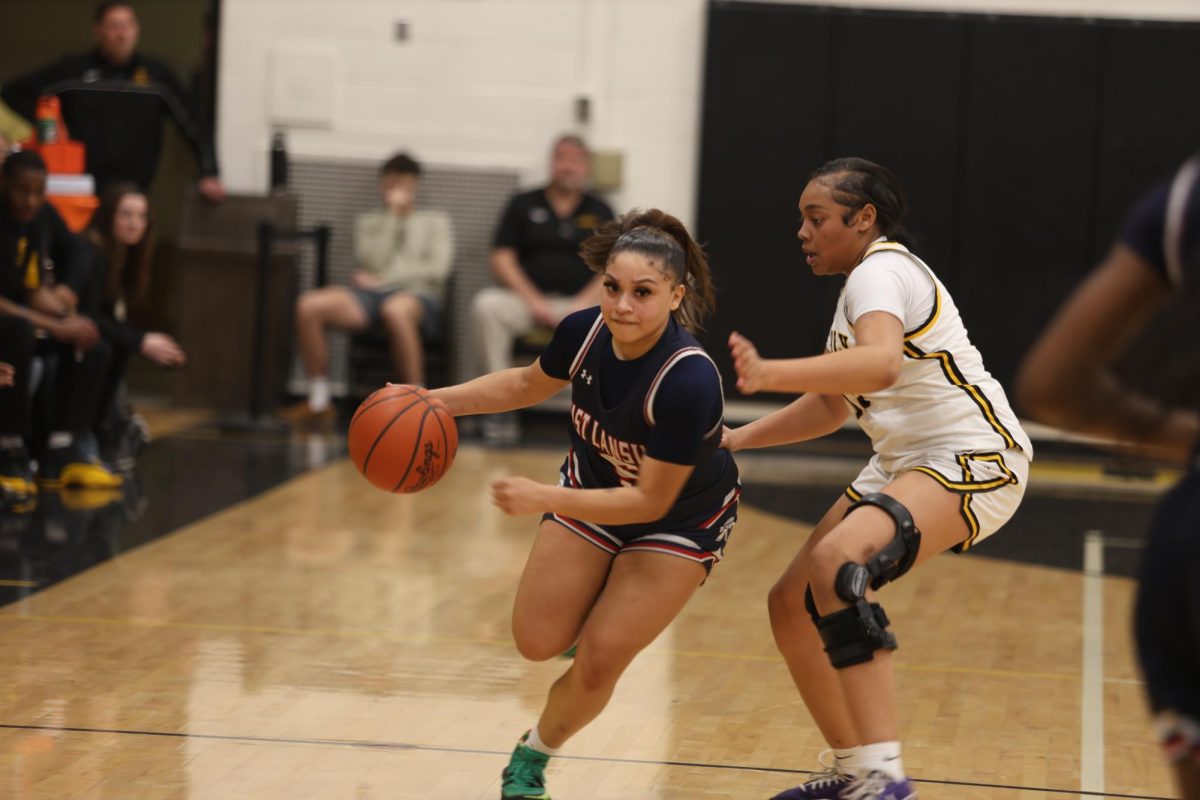 Aniaya Mendenhall (12) drives the ball away from a Waverly player on Feb. 6. Mendenhall scored the last shot of the game, making the final score against Waverly 44-42. 