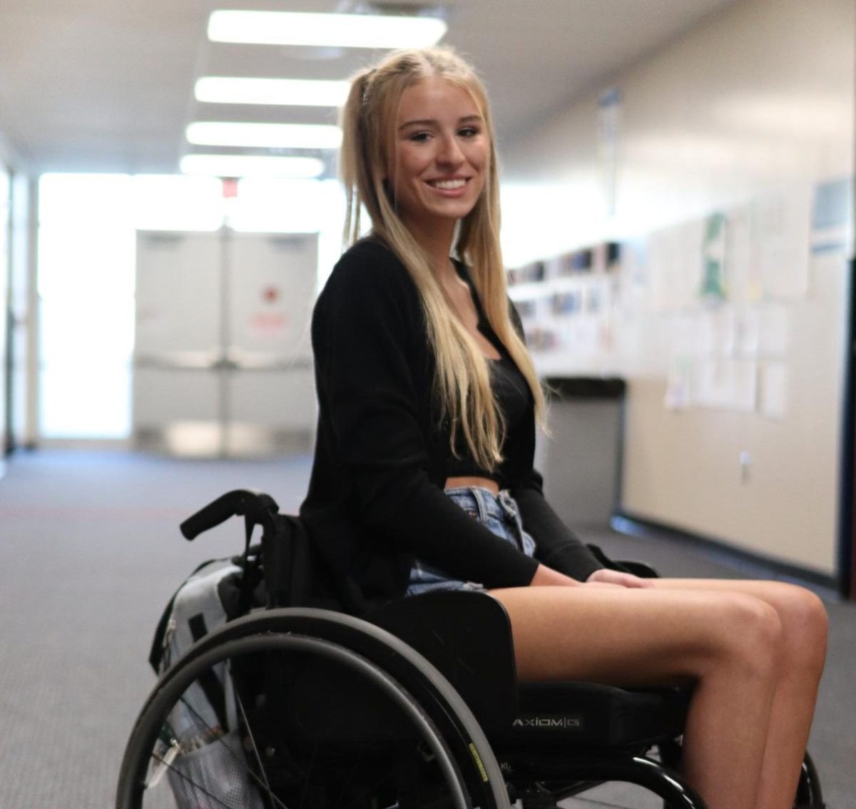 Lainey Hampton (12) poses in the hallway during the school day on April 17. Hampton recently moved to Michigan from Florida.