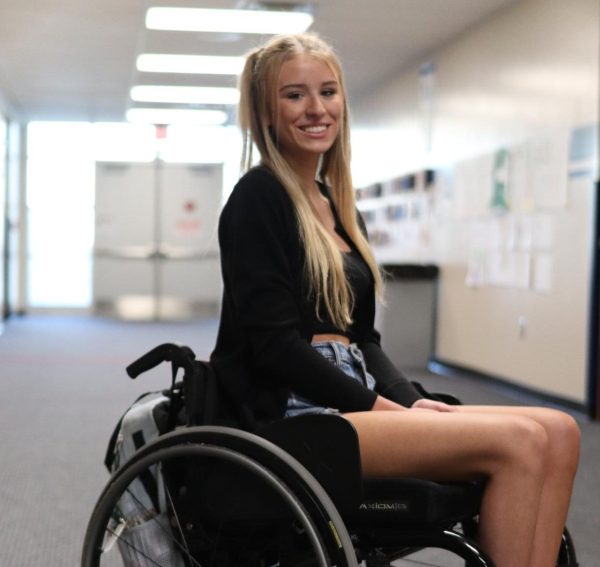 Lainey Hampton (12) poses in the hallway during the school day on April 17. Hampton recently moved to Michigan from Florida.