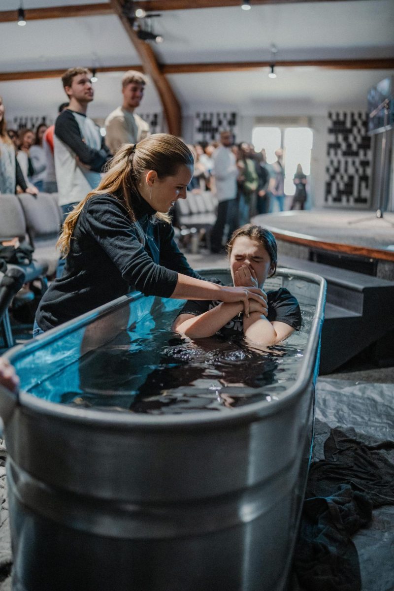 Katie Flynn (12) baptizes Molly Shaw (10) on Feb. 23. Both Flynn and Shaw attend the Commons Church. Courtesy photo.