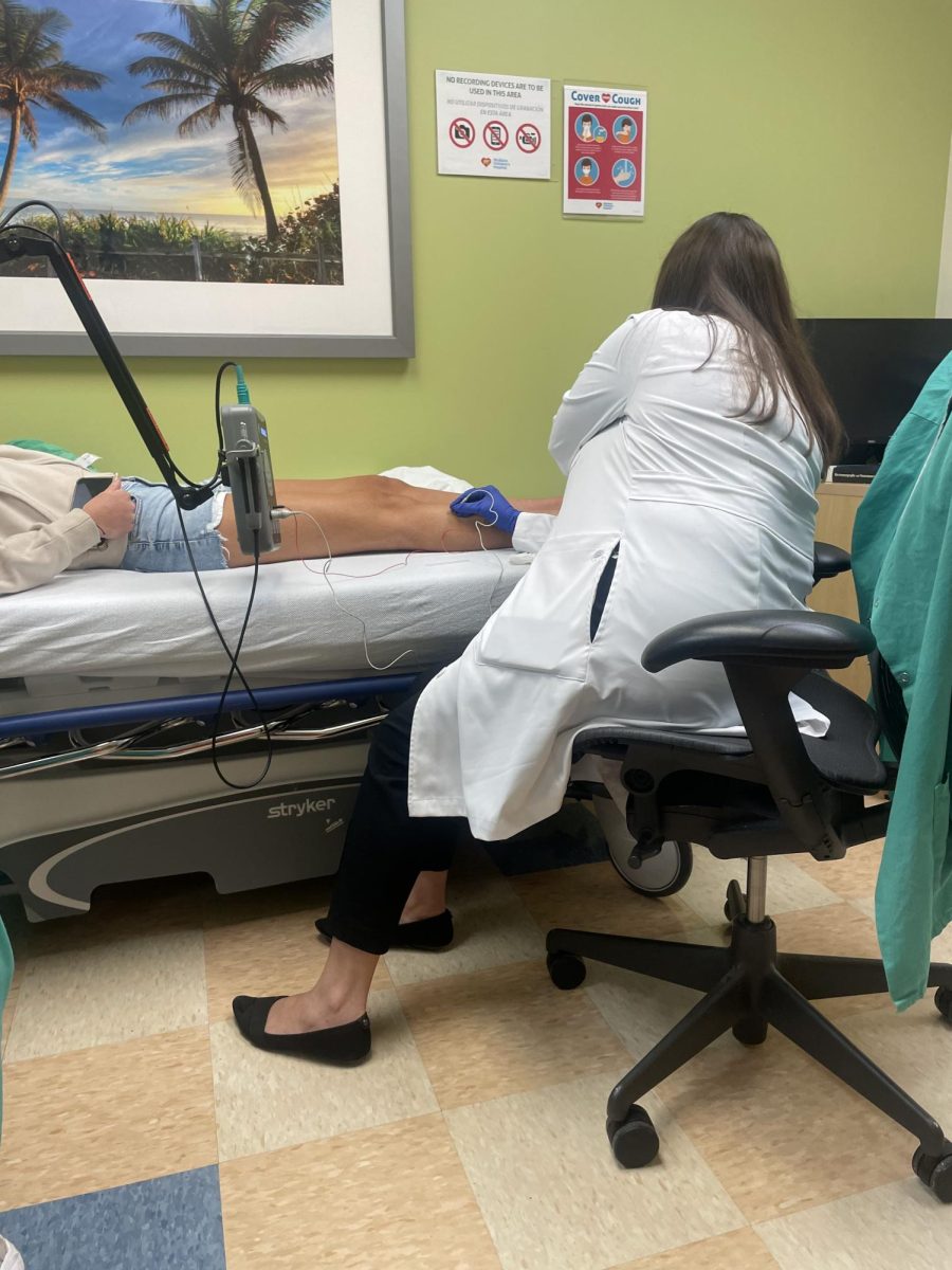 Laying in a doctor's office in Miami on April 24, 2023, Lainey Hampton (12) receives one of many tests to rule out potential causes for her lack of mobility. This specific test was a nerve test.