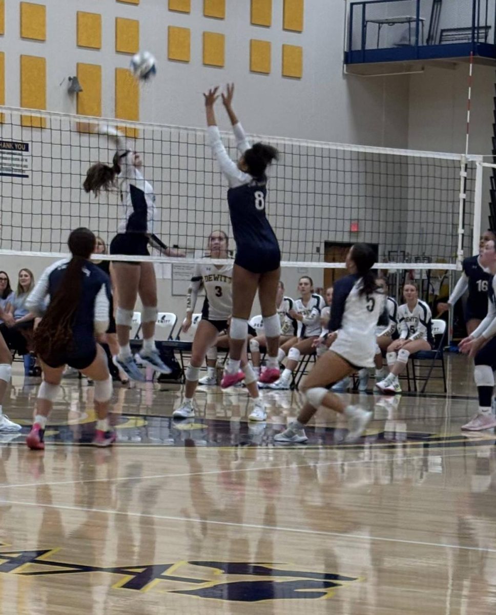 During a game against DeWitt on Sep. 18, Ariyanna Johnson (12) blocks a spike. Johnson was named Portrait's September 2025 athlete of the month.
