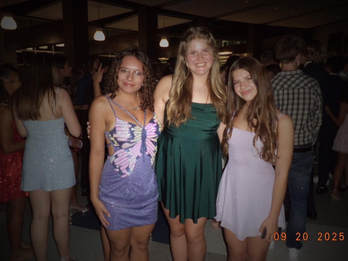 Maya Shuptar (12), Nelly Flynn (10) and Mayra Cangelosi (10) pose during the homecoming dance on Sep. 20 in the student union.