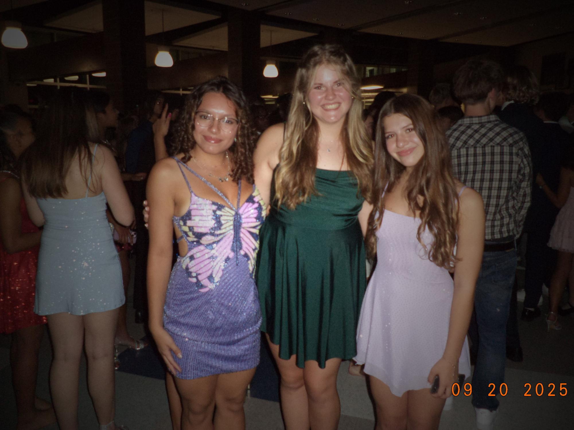 Maya Shuptar (12), Nelly Flynn (10) and Mayra Cangelosi (10) pose during the homecoming dance on Sep. 20 in the student union.
