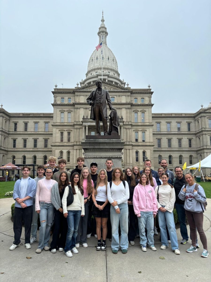 German teachers Bob Filter (back row, right) and Adam Orange (middle row, right) pose with German exchange students during a trip to the Lansing State Capitol. 
Photo courtesy of Bob Filter