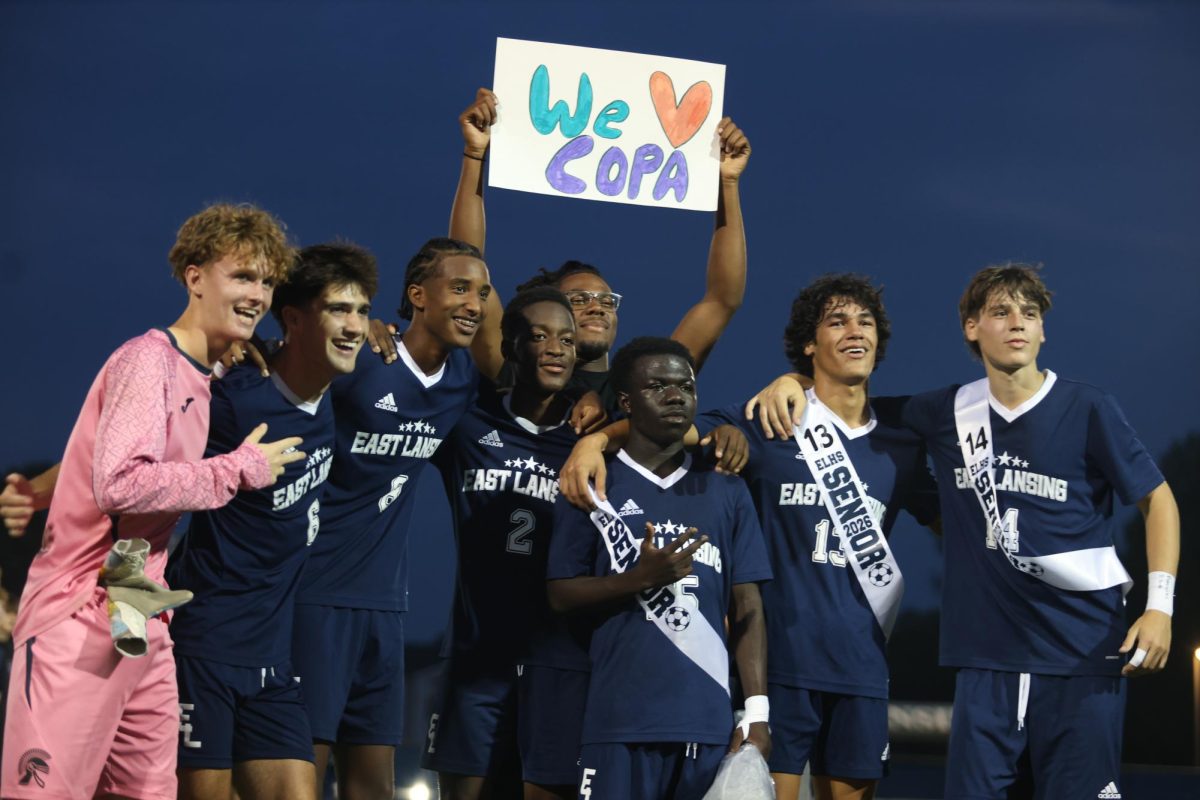 During senior night on Sept. 18, the boys' varsity soccer team celebrates Copa Manoti's (12) return to the field. Manoti hasn't played with the team since 2023.