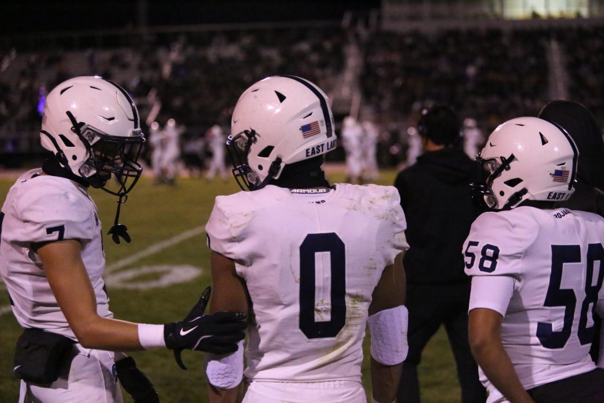 During their 11/25 game at Holt high school. Jace Clarizio (12) talks to teammates Owen Fortman (12) and Riel Flores (12)