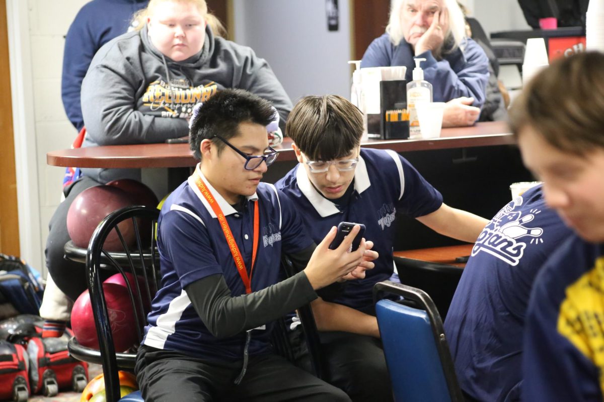 Brayden Lewis Farver (11) sits alongside teammate Isaac Garza (10) at their bowling match agaisnt Dewitt on 12/13/24.