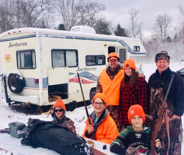 The Moore family, including Miles Johnston (12) (middle, kneeling) and 
Nola Moore (12) (middle, standing) pose during a family hunting trip 
during their youth. While Moore got her hunting license two years ago, she's been hunting since she was a child.
