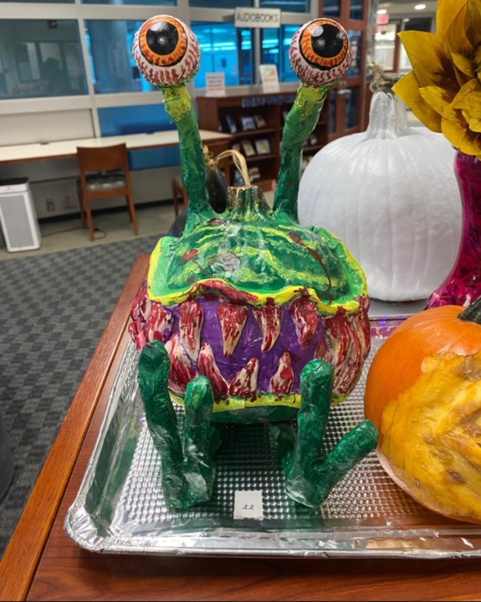 Showing off her pumpkin decorated as an alien. Marwa Djomheri's (12) pumpkin won the contest last year. This years contest will start on Oct. 23. Courtesy by Marwa Djomheri
