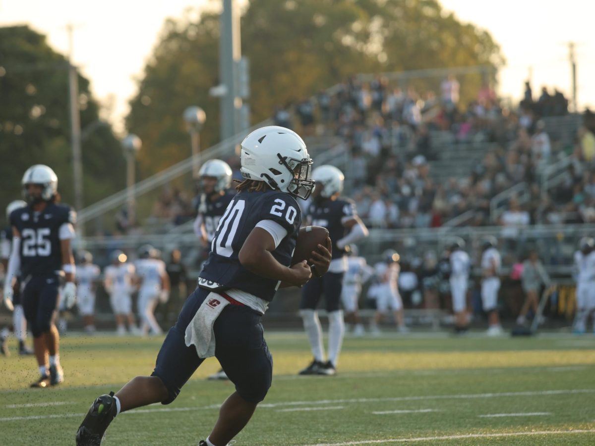 Catching a pass, running back Jeremiah Fry (9) runs for the end zone. East Lansing won
the game 22-13 against Okemos on Friday, Sep 19, 2025
