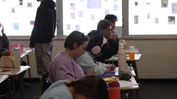 Completing a worksheet, Farrah Hodkinson (12) participates in her Junior Trojan Mentoring 1 class. She mentors students at Red Cedar Elementary.