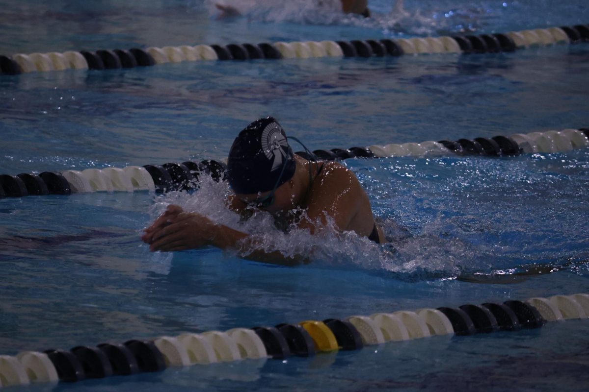 Swimming in a home meet against St. Johns on Sep. 18, Ava Harmon (11) races for first in the 100 breaststroke. Harmon swam this event almost every meet in the 2025 season after training for it over the summer. 