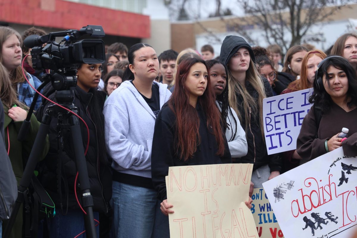 Holding up their signs, many students listen to Jessica Mielock (12) speak out about the involvement of ICE in the United States during a walkout staged by Students for Political Action (SPA). The walkout took place on Friday, Jan. 9.