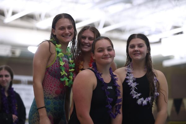 Waiting to receive their fifth place award for the 200 freestyle relay, Kate Aupperlee (12), Olin Moyer (12), Zoe Salvador (10) and Ava Harmon (11) smile for a celebratory picture on Nov 8. The relay competed at the state meet on Nov 21. 