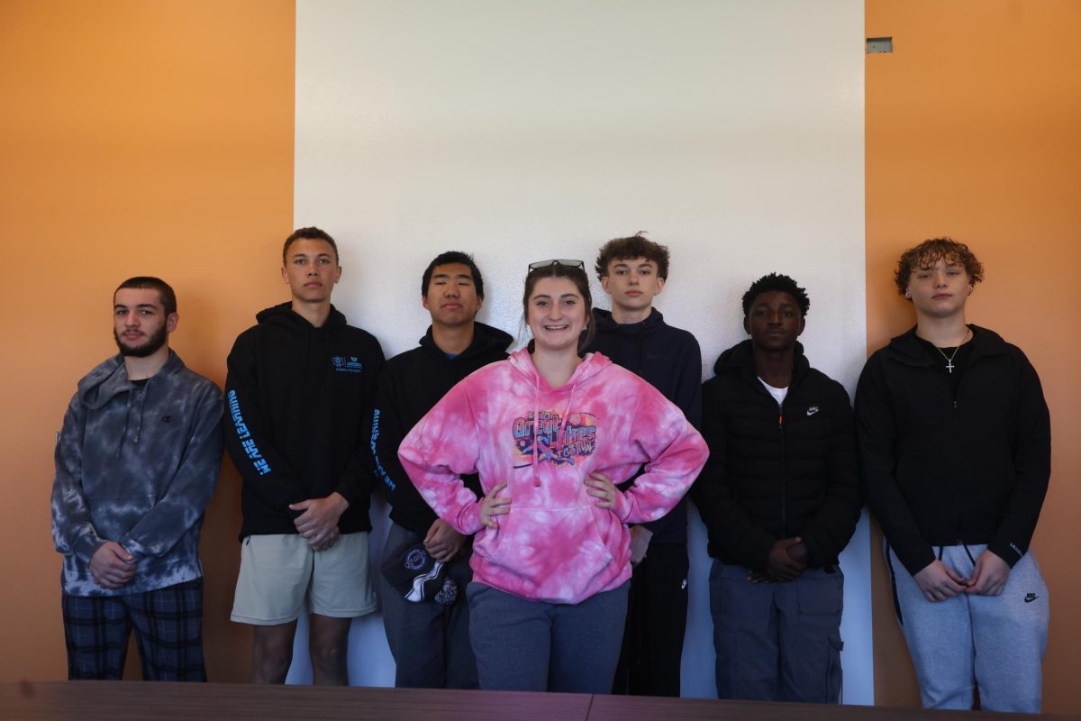 Wilson Talent Center Cybersecurity student Taylor Martin (12) poses in front  of six male classmates on Oct. 29. Martin was one of five girls in a class of 41 total. 