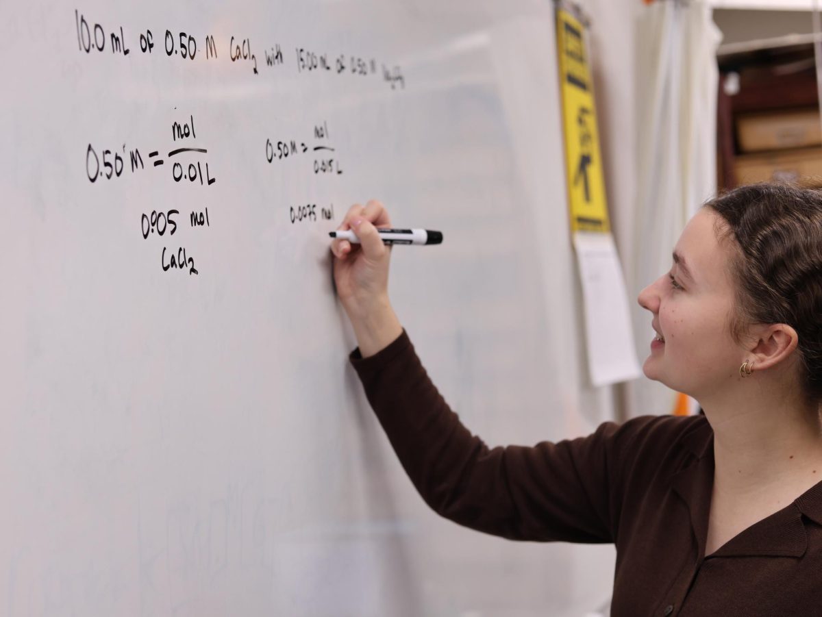 Writing chemical equations, Adelina Schenker (12) practices for Science Olympiad during excel. The Science Olympiad team recieved 6th place, winning many individual awards, during their recent competition at Haslett.