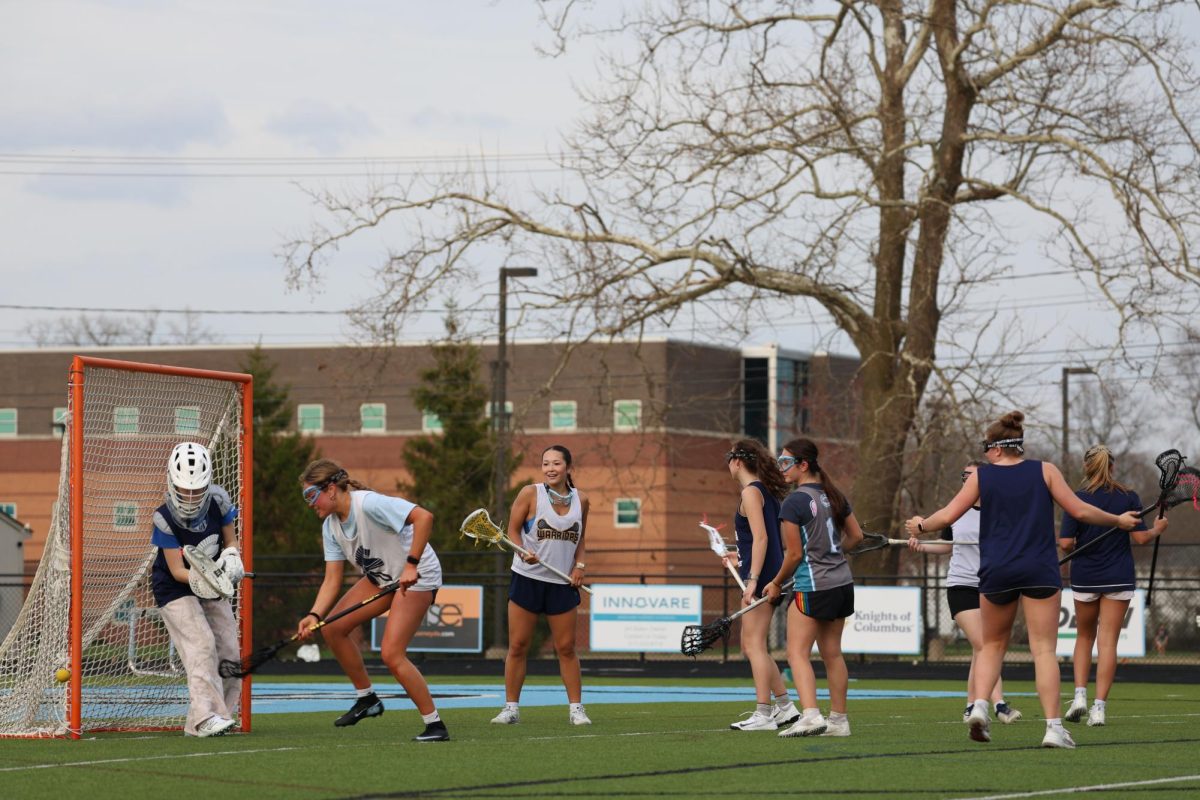 Chasing the ball, Elizabeth Wright (12) practices lacrosse at Lansing Catholic on April 13. The team primarily played their games at East Lansing facilities.