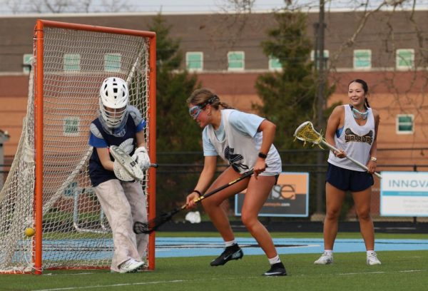 Chasing the ball, Elizabeth Wright (12) practices lacrosse at Lansing Catholic on April 13. The team primarily played their games at East Lansing facilities.